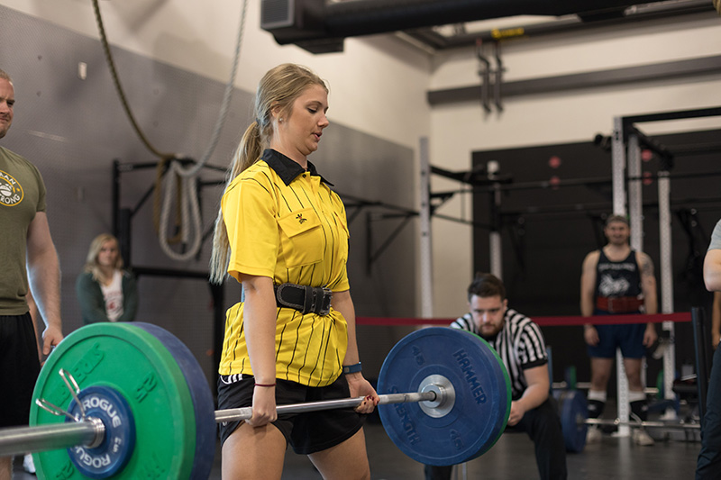 person lifts barbell
